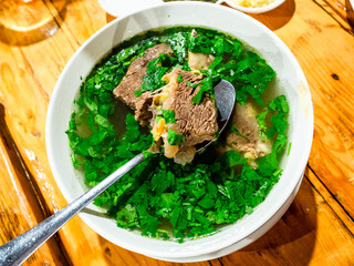 Georgian Khashlama stew in bowl on wooden table