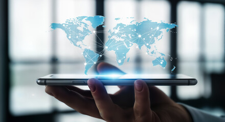 A hand holding a smartphone displaying a glowing blue digital world map hologram, representing global connectivity and technology
