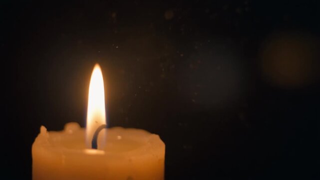 Cinematic Candle Flame with Floating Dust Particles in Warm Light. 