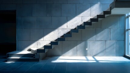 Obraz premium Diagonal sunlight illuminates modern minimalist staircase against a large block wall