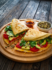 Healthy breakfast - italian piada wraps with scrambled eggs, tomatoes, avocado, coriander and bean sprouts