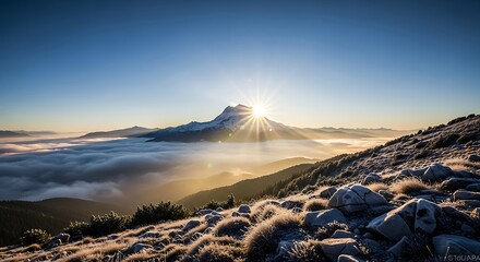 Sunrise over mountain peak above clouds