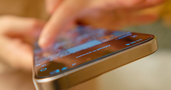 Close up woman scrolling through social media app on smartphone, engaging with digital content and staying connected in modern communication landscape