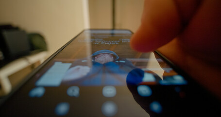 Finger swiping across smartphone screen, navigating personal social media feed with quick, fluid digital gestures revealing online content