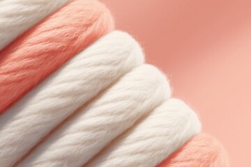 Soft yarn in pastel colors. Pink and white wool strands stacked together