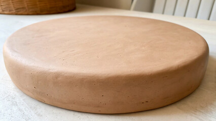 Round Terracotta Cake Stand or Platter on a Table clay ceramic Background