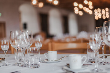 Majestic medieval castle banquet hall with long wooden tables, chandeliers, and stone walls illuminated by warm candlelight, evoking the atmosphere of royal feasts.