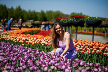Joyful moments in a colorful tulip field during spring showcasing vibrant blossoms under a clear blue sky