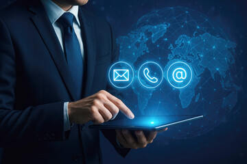 Businessman using tablet with world map and contact icons for email phone and at symbol communication
