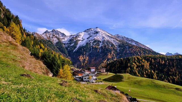 Autumn alpine meadow with Hofle village below Hemerkogel peak in the Oetztal Alps Austria, timelapse