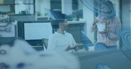Man leaning and making point, woman eating with chopsticks smiling, blue overlay tinting office