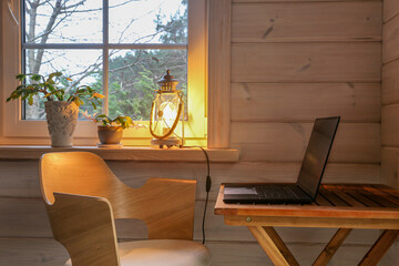 Mindful home workspace with laptop, Christmas cactus and lantern light on wooden windowsill, cozy Scandinavian interior, calm atmosphere for creative work, self care, wellness and winter inspiration