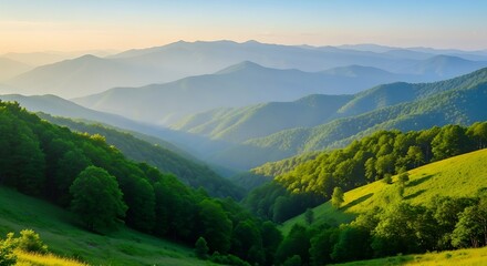 Misty mountain range at sunrise with green valleys