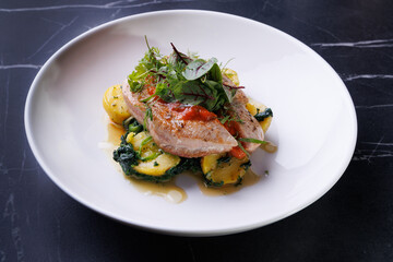 Gourmet Pork With Potatoes and Fresh Greens Plated