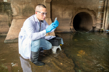 Scientists collected water samples from the drainage tunnel with syringes for testing