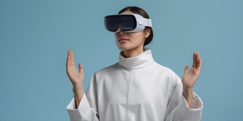 Young asian female in futuristic outfit using virtual reality headset against blue background