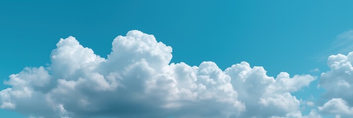 Bright blue sky with white fluffy clouds on a clear day