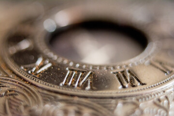 Macro photograph of a pocket watch.