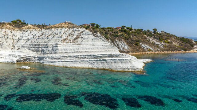 Aerial view of the Scala dei Turchi (Stair of the Turks or Turkish Steps) on coast of Sicily, Italy. It's a rocky cliff formed by marl, a sedimentary rock with white color. It overlooks turquoise sea.