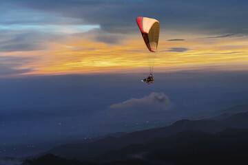 Paragliding over the clouds sunset view at Bir Billing Himachal Pradesh India. Clouds in the sky, Dhauladhar peaks view
