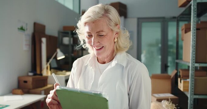 Woman, tablet and smile for dropshipping at startup, writing notes and inventory management at warehouse. Mature person, entrepreneur and tech with app, thinking or supply chain at small business