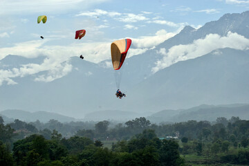 Paragliding over the clouds at Bir Billing Himachal Pradesh India. Clouds in the sky, Dhauladhar peaks view