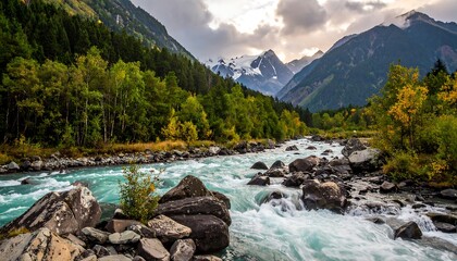 Scenic mountain river flanked by colorful trees, with snow-capped peaks in the background under a cloudy sky