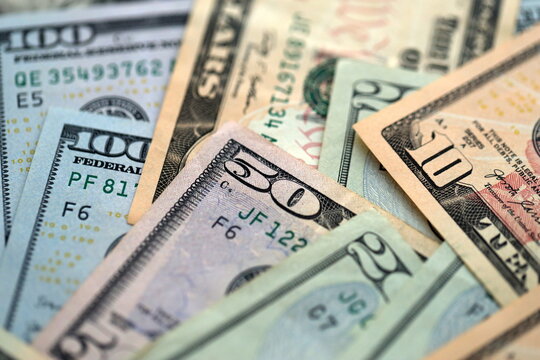 Big amount of different dollar bills close up. Hundred fifty twenty ten and five dollar banknotes