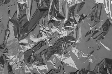 Silver crumpled foil texture on flat surface