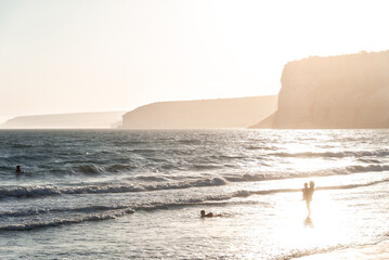 Family enjoying sunset at Kourion beach in Cyprus