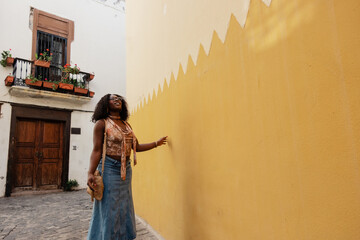 Young woman enjoying summer travel in European alley street