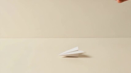 Paper airplane hand beige minimalism flying toy creativity simple white craft design flight concept smooth surface light shadow close up leisure childhood play idea