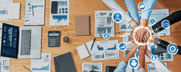 Aerial view of a team collaborating over business documents and technology, fostering creativity...