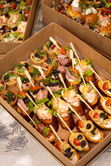 Catering box with assorted canapes and bruschetta for party buffet and delivery