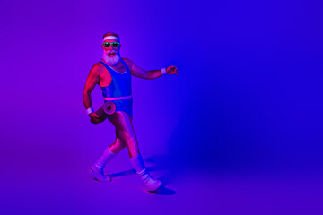 Retro fitness dancer in neon blue studio lights wearing a jumpsuit and roller under purple glow