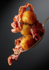 Roasted potatoes with bacon sprinkled with spices.