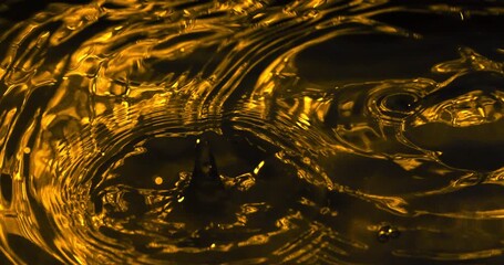 Slow Motion Macro Shot Of A Golden Water Droplet Creating Ripples And Splashes In Liquid Motion At 1000 Fps. Concept Of Purity And Fluid Energy - Powered by Adobe