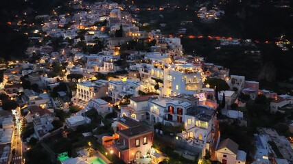 Evening lights illuminate charming architecture in Positano Italy as seen from an aerial perspective offering a glimpse of this beautiful village - Powered by Adobe