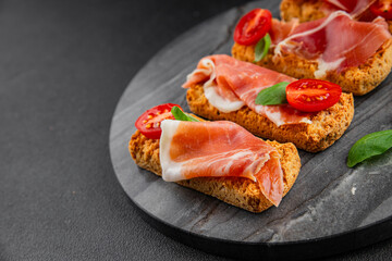 jamon bruschetta prosciutto appetizer portioned tapas dish natural tasty snack fresh delicious gourmet food background on the table rustic top view copy space