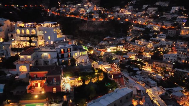 Aerial night view overlooking illuminated houses and buildings of beautiful Positano Italy on the Amalfi Coast