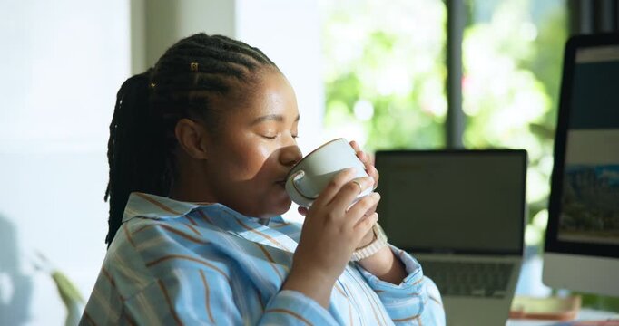 Home, thinking and woman with coffee, remote work and start day with hot beverage, calm and drinking. Morning, mindfulness and black person with tea for health benefits, freelancer and caffeine boost