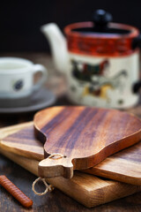 Set table with wooden boards, teapot and cup, copy space for text