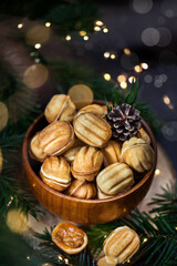 Homemade Russian cookies "Nuts" with boiled condensed milk filling on a holiday background