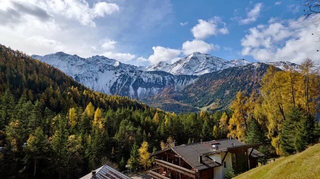 Autumn Alpine Valley with Snowy Mountain Ridge and Colorful Forest in the Otztal Alps, timelapse
