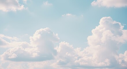Fluffy White Clouds Against a Pastel Blue Sky, Serene and Dreamy.