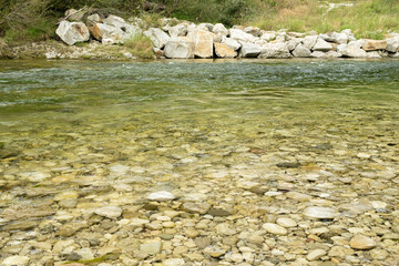 Close-up of a turbulent mountain river with a rocky bottom and shore