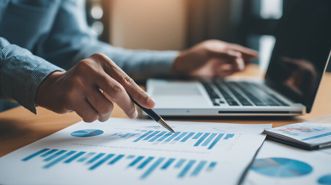 Analyzing financial data charts with laptop for business investment