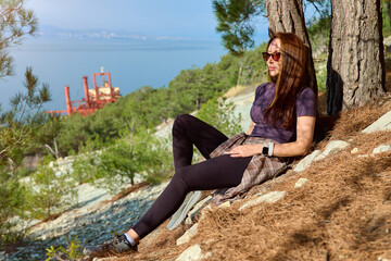girl stands against the background of a crashed ship