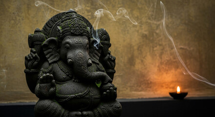 Serene stone statue of the Hindu deity Ganesha with offerings of incense smoke and a lit candle