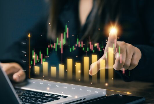 Hand pointing to digital financial chart with bar and candlestick graph. Concept of business success, investment, growth strategy, and data-driven marketing.